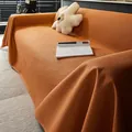 Orange waffle weave waterproof sofa cover protector showing soft texture and drape - Caramel color