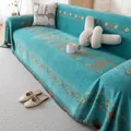 Bohemian chenille sofa cover in turquoise with geometric patterns and fringe - Green