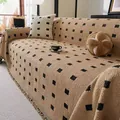 Thick beige yarn sofa cover with black geometric squares and decorative fringe trim - 180*130 / Brown