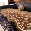 Brown chenille sofa cover with white animal pattern and wavy edge on black leather sofa - 90x70 / Brown