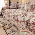 Artistic floral throw blanket with tassels and a matching garden pillow on a sofa - 180x380cm / Orange