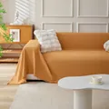 Ginger yellow waffle texture sofa cover with decorative fringe trim on white couch - 180x130 / Orange