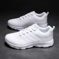 Detailed close-up of white breathable mesh sneakers with thick soles on concrete - EU 35 / White