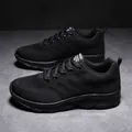 Macro detail of breathable mesh fabric and fashion label on the black running shoe - EU 35 / Black