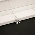 Close-up of dreamcatcher necklace pendant with carved feathers on black leather - X140/pumeng.com