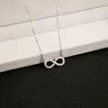 Macro shot of silver infinity pendant necklace with micro-pave cubic zirconia inlay - X141/bow