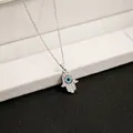 Macro shot of silver Hamsa Hand necklace with blue evil eye and sparkling rhinestones - X147/hand