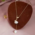 Detail of rose pendant necklace with white flower and gold leaves on a velvet background - Gold Vintage 3D Rose Necklace