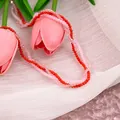Detailed close-up of layered red and pink faceted beads on a stylish necklace - X888/red