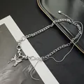 Detail of layered silver butterfly pendant necklace with snake chain and chunky cuban links - X708