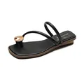 Elegant black thong sandals with thin straps and gold metal disc accents on flat soles - EU 35 / Black