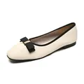 Elegant beige flat shoes with black bow and gold buckle detail on a 45-degree angle view - EU 35 / Apricot