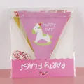 Detail of paper party flags with carousel horse print and Happy Day text in packaging - Pink Rocking Horse Banner