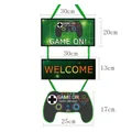 Game on birthday party banner set with gamepad hanger and dimensions in green and black - Game Controller Door Curtain