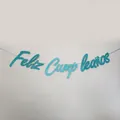 Close-up of glittery blue Feliz Cumpleaños banner with elegant cursive lettering - Glitter Sky Blue