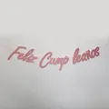 Close-up of pink glittery Feliz Cumpleaños banner for Spanish birthday party decor - Glitter Rose Gold