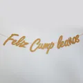 Close-up of golden glitter Feliz Cumpleaños birthday banner with cursive calligraphy detail - Glitter Gold