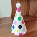Detailed view of colorful polka dot party hat with a white plush pompom on top - One Size / Colorful Large Polka Dot Birthday Hat