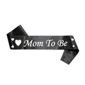 Detail of black satin Mom To Be sash with white lettering and hearts for baby showers - Black Mom To Be