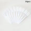 Set of 10 disposable white plastic forks arranged in a fan shape for pet party decor - White Dinner Fork