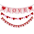 Close-up of Valentine's Day party banners with pink LOVE flag, heart strings and red XOXO signs - LOVE Banner and Heart Garland Combo