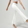 High-waist flared yoga pants in solid white featuring high elasticity and slim fit design - M / Off-white