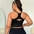 Black ribbed knit sports bra featuring racerback design and teardrop cutout detail - XL / Black