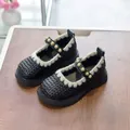 Girls' black Mary Jane shoes with lace trim and pearl accents on elegant wooden background - Size 21 / Black