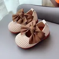 Beige knitted toddler shoes with large brown satin bow and soft non-slip rubber soles - Size 15 / Off White