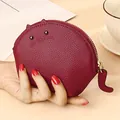 Burgundy cat-shaped genuine leather mini coin purse held by hand for scale display - Burgundy