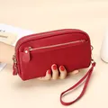Red pebbled leather long wallet clutch with triple zippers and gold-tone hardware - Red