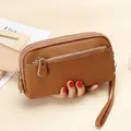 Brown litchi grain cowhide leather clutch bag with multiple zipper compartments - Earthy Yellow