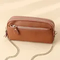 Brown litchi texture leather crossbody bag with triple zipper layers and gold chain - Earthy Yellow