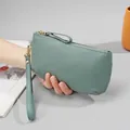 Pea green grained leather clutch wallet with gold zipper and wristlet strap for women - Flax Blue