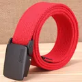 Detailed close-up of a red woven canvas belt with a black tactical buckle on wood background - Red