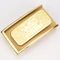 Detail of golden stainless steel automatic belt buckle with textured TUSHI logo panel - Gold
