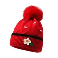 Cute red knitted baby hat with large pompom and small daisy floral detail - One Size / Burgundy