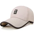 Close-up of breathable mesh fabric and logo patch on a foldable outdoor baseball cap - Adjustable / Khaki