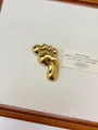 Polished gold footprint shaped brooch with glossy metallic finish on textured pad - 59 Gold Footprint Shape (XZ0132) / Gold