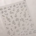 Detalle de pegatinas 3D plateadas para uñas con rosas en relieve y base adhesiva - Tk018