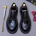 Black leather oxford shoes with colorful stitching and a classic wingtip design - EU 37 / Black