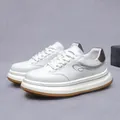 White leather men's sneakers with brown sole and heel detail in a side view profile - EU 38 / White and Brown