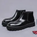 Polished black leather men's Chelsea boots with wingtip brogue patterns and thick lug soles - EU 38 / Black