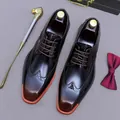Polished brown leather brogue shoes with orange sole accent and intricate wingtip details - EU 38 / Patina Brown