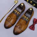 Brown leather brogue shoes with tassels and elegant business accessories on grey surface - EU 37 / Brown