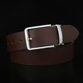 Detail of dark brown leather belt with fine perforated texture and silver metal buckle - Standard Size / Coffee