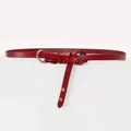 Detail of burgundy leather wrap belt featuring a gold O-ring buckle and rivet accents - 95-110cm / Burgundy
