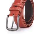 Detail of orange brown leather belt showing litchi texture and gunmetal pin buckle - 120cm / Red Brown