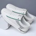 White casual sneakers with breathable mesh holes and green navy stripe details - EU 38 / White