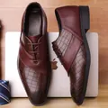 Formal brown derby shoes with crocodile texture and leather stitching on a wood surface - Burgundy